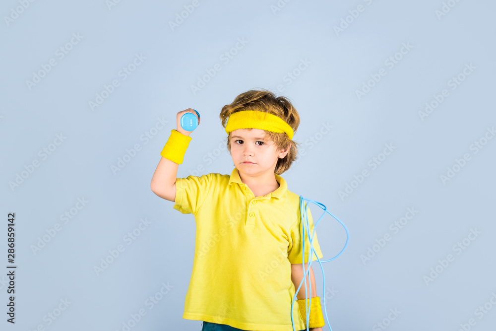 Sport. Fitness child. Sporty boy with jump rope and dumbbells. Fitness, health and energy. Boy in sportwear with skipping rope and dumbbells. Gym workout. Success. Child sportsman. Childhood activity. Sport. Fitness child. Sporty boy with jump rope and dumbbells. Fitness, health and energy. Boy in sportwear with skipping rope and dumbbells. Gym workout. Success. Child sportsman. Childhood activity.