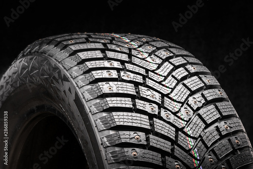 new premium winter studded tires on a dark black background