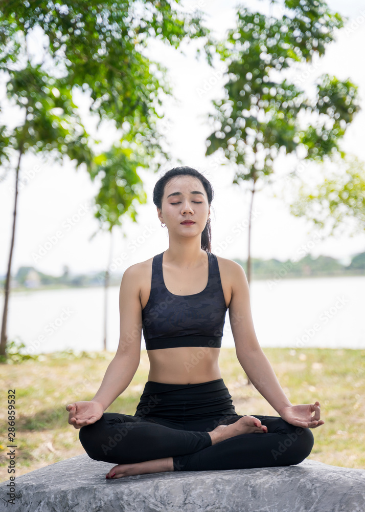 Young beautiful woman practices yoga and meditates outdoor at the mountain. Female doing yoga and meditate to relax and release stress. Young beautiful woman practices yoga and meditates outdoor at the mountain. Female doing yoga and meditate to relax and release stress.