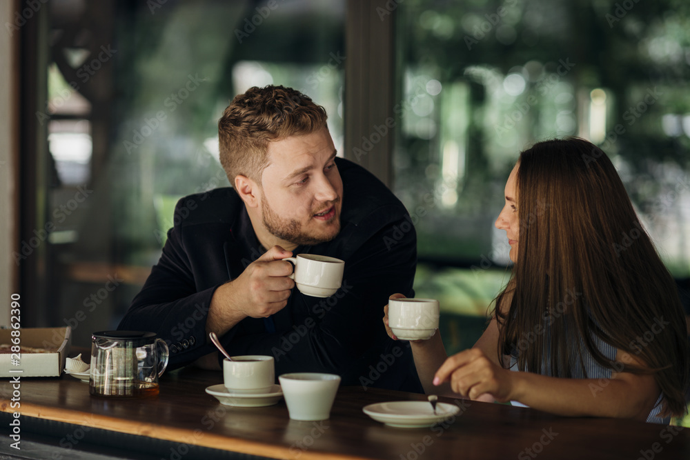 Young couple drinking tea in cafe