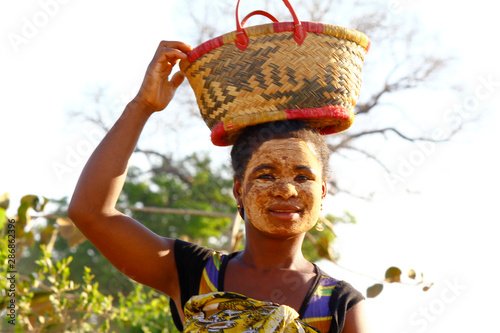 Portrait of Malagasy woman with traditional mask on the face, Madagascar