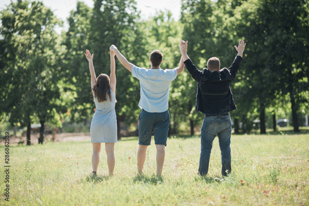 United people standing and holding hands up United people standing and holding hands up