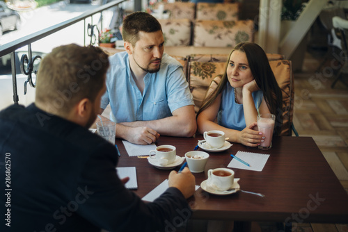 Relaxed people communicating and drinking coffee and milkshake in cafe