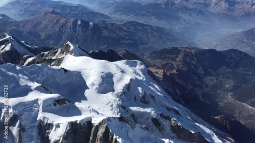 Mont Blanc mountain peak and glacier cinematic aerial shot. Scenic view, snowy peak with the valley in the background