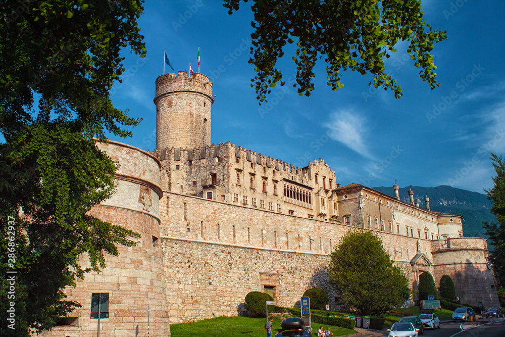 Trento, Italy - Buonconsiglio Castle (Castello del Buonconsiglio) - medieval castle with tower, blue sky in the backround