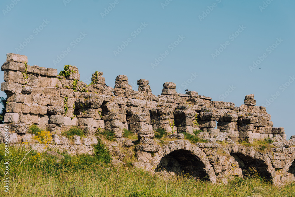 Old aqueduct in Side. Ruins of the ancient city of Turkey. Antalya coast.Antalya Province. Pamphylia. Ancient building. Historical place