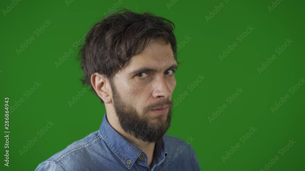 Good looking, dark-haired man playfully makes funny faces -grins, grimaces, crosses his eyes, winks Good looking, dark-haired man playfully makes funny faces -grins, grimaces, crosses his eyes, winks