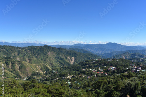 Small town in the mountains in summer time with clear blue sky.