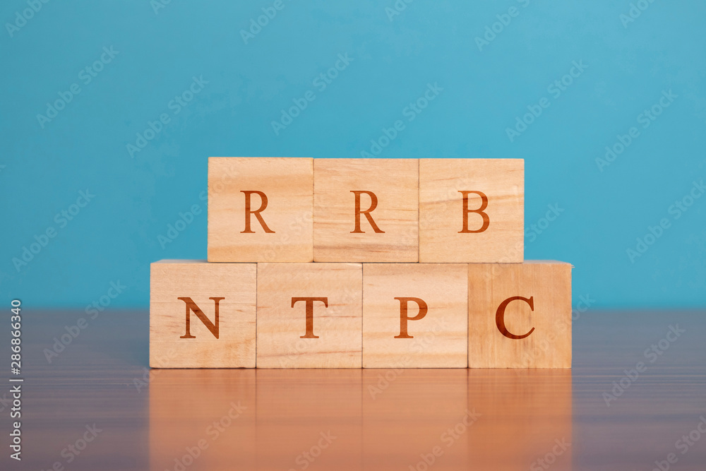 Concpet of RRB NTPC exam conducted in India for recruitment, RRB NTPC Exam on Wooden block letters. Concpet of RRB NTPC exam conducted in India for recruitment, RRB NTPC Exam on Wooden block letters.