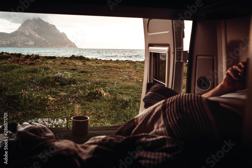 View from camper van on beach, sea and mountain photo