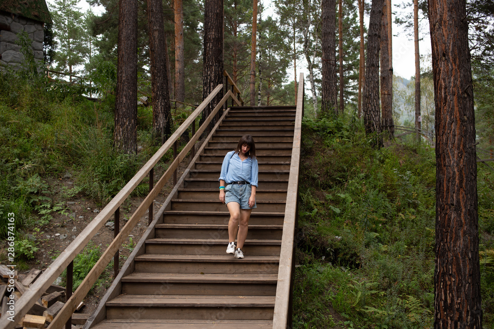 unhappy woman walking in the forest park