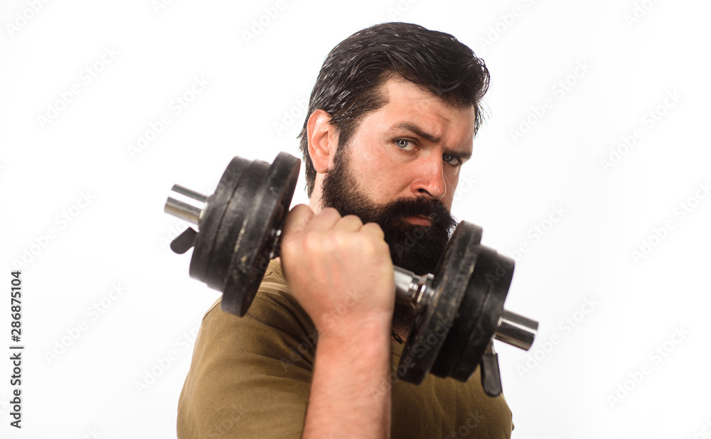 Athletic young male fitness model holds dumbbell. Handsome man lifting  dumbbell at gym. Healthy sports lifestyle, fitness concept. Fit young man  in sportswear holds dumbbell during workout in gym. Stock Photo