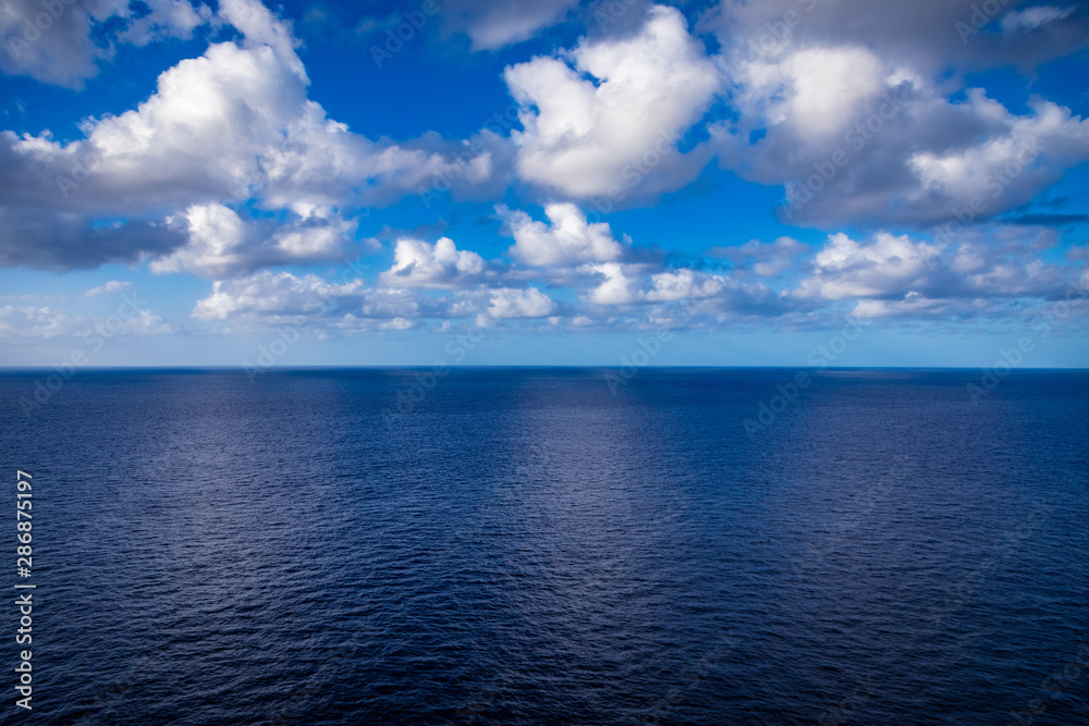 Calm ocean and a few clouds off the coast of Hawaii
