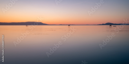 fishing sunset reflection smooth lake balaton dusk dawn sunrise evening fonyód district hungary summer vacation travel relax