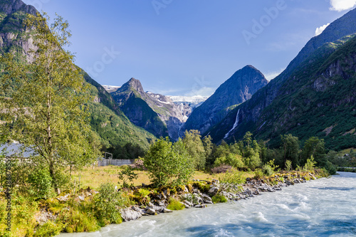 Oldedalen valley with majestic mountains, rivers, waterfalls and impressive Jostedalsbreen glacier in the background in Norway, Scandinavia