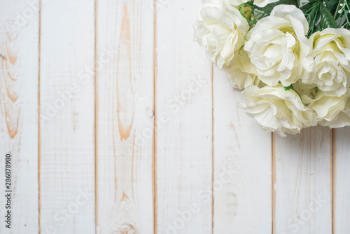 Top view of wedding flowers on white wood background © tonefotografia
