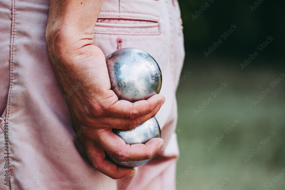 Boules de jeu de pétanque dans les mains d'un homme