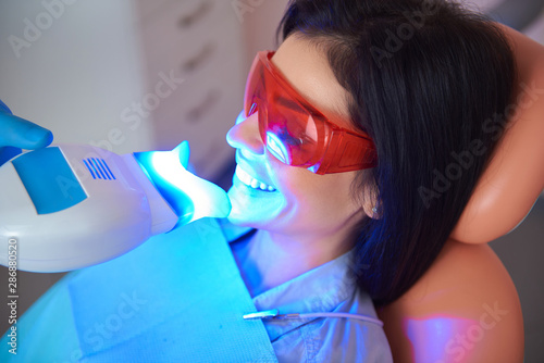 Happy woman with eyes closed in dentist chair photo