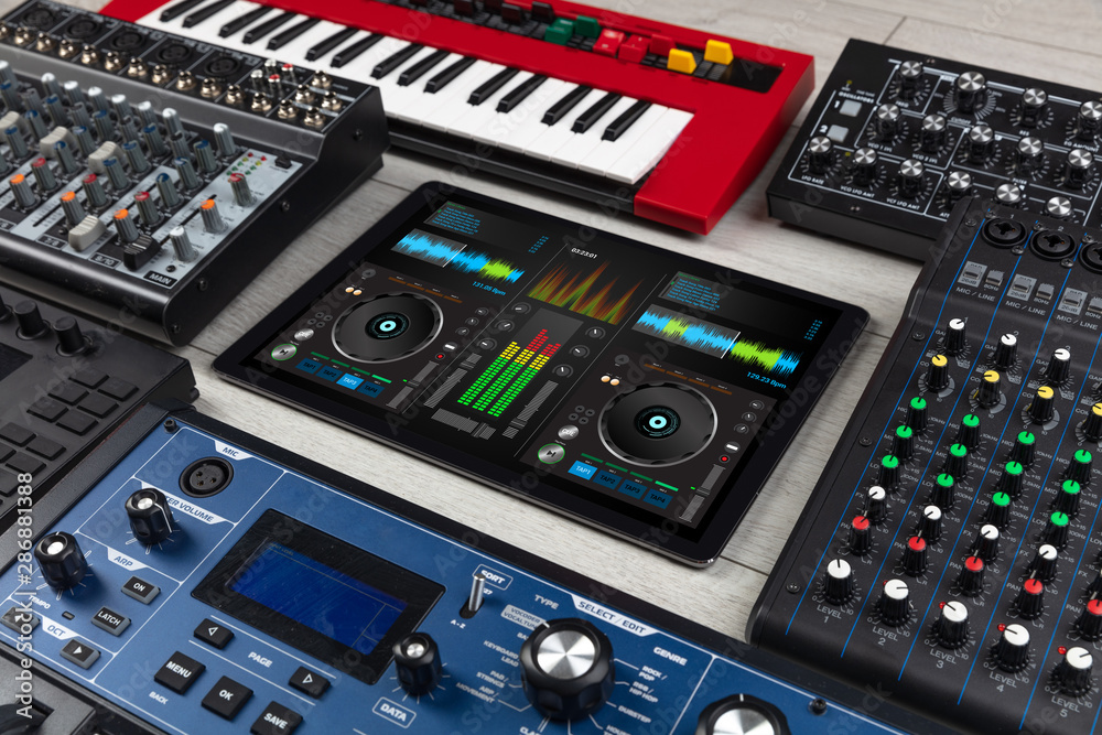 Mixing music on tablet with electronic music instruments concept Mixing music on tablet with electronic music instruments concept