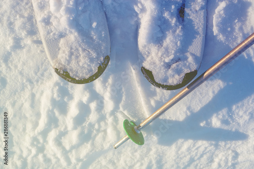 Ski with pole on white snow trail in ski resort for winter sport concept.