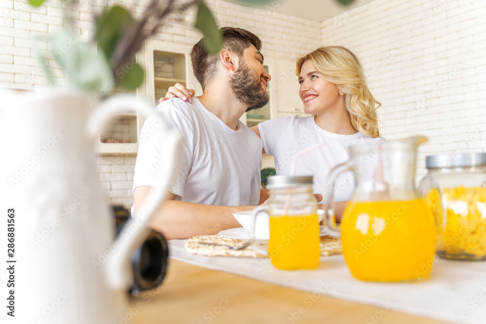 Happy couple is sitting on the kitchen Happy couple is sitting on the kitchen