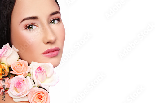 Young beautiful woman with natural makeup and pink roses  copy space