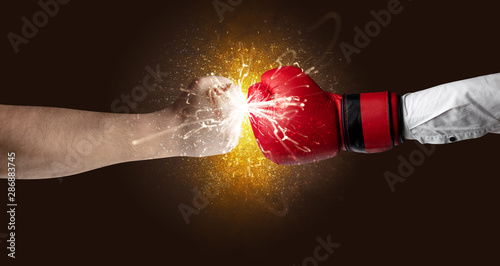 Two hands fighting with orange dust, spark, glow and smoke concept © ra2 studio