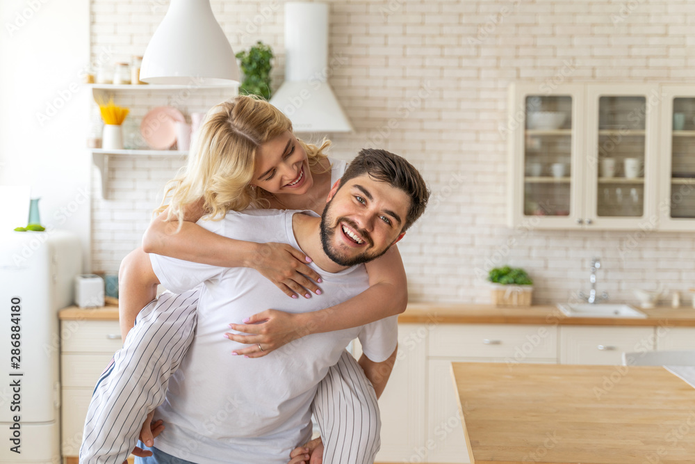 Pretty young woman is hugging smiling man Pretty young woman is hugging smiling man