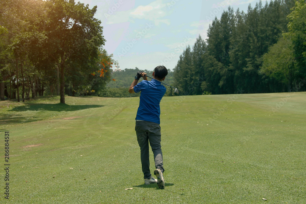 Golfer playing golf in beautiful golf course in the evening golf course with sunshine in thailand Golfer playing golf in beautiful golf course in the evening golf course with sunshine in thailand