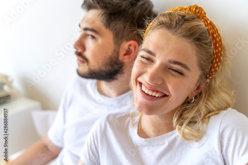 Young woman is laughing near bearded man