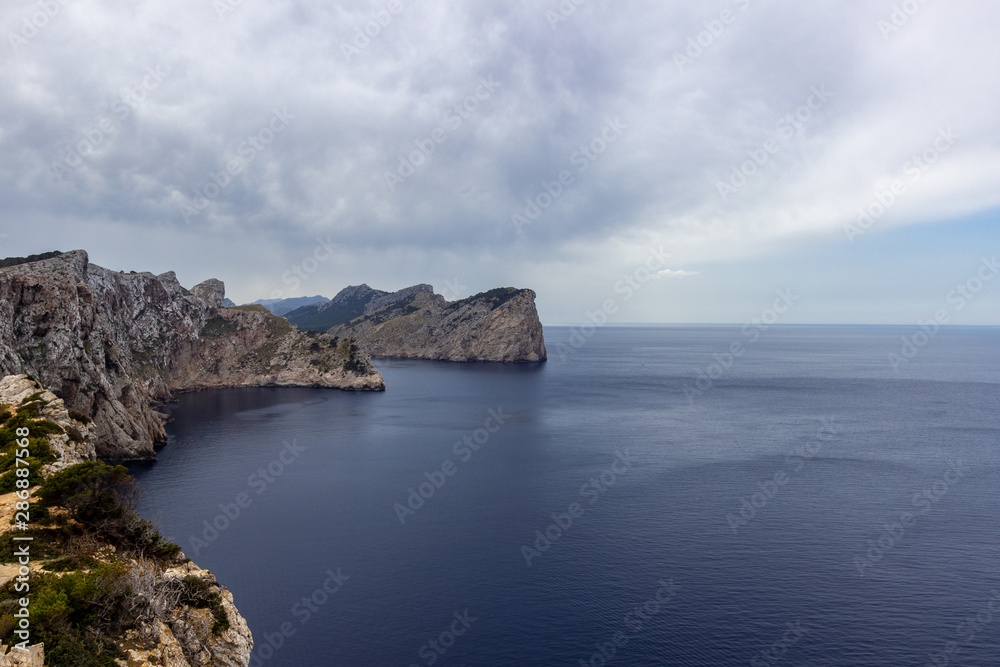 Scenic view on the coast at bay Cap de Formentor on balearic island Mallorca, Spain on a sunny day with clear blue water an rocky coastline