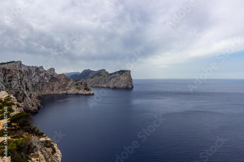 Scenic view on the coast at bay Cap de Formentor on balearic island Mallorca, Spain on a sunny day with clear blue water an rocky coastline