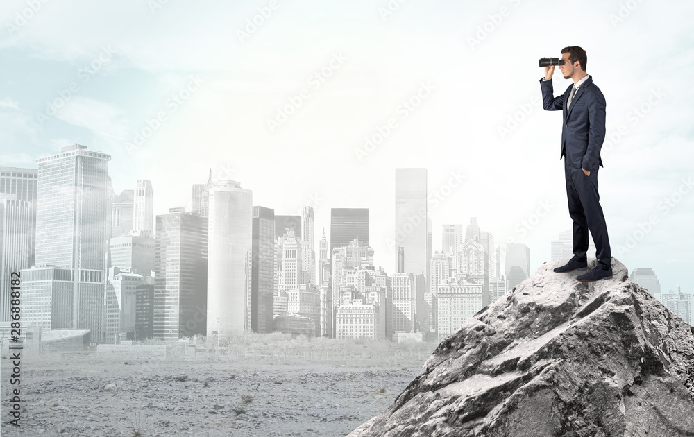 Young architect looking to ruined city from distance and thinking about investments Young architect looking to ruined city from distance and thinking about investments