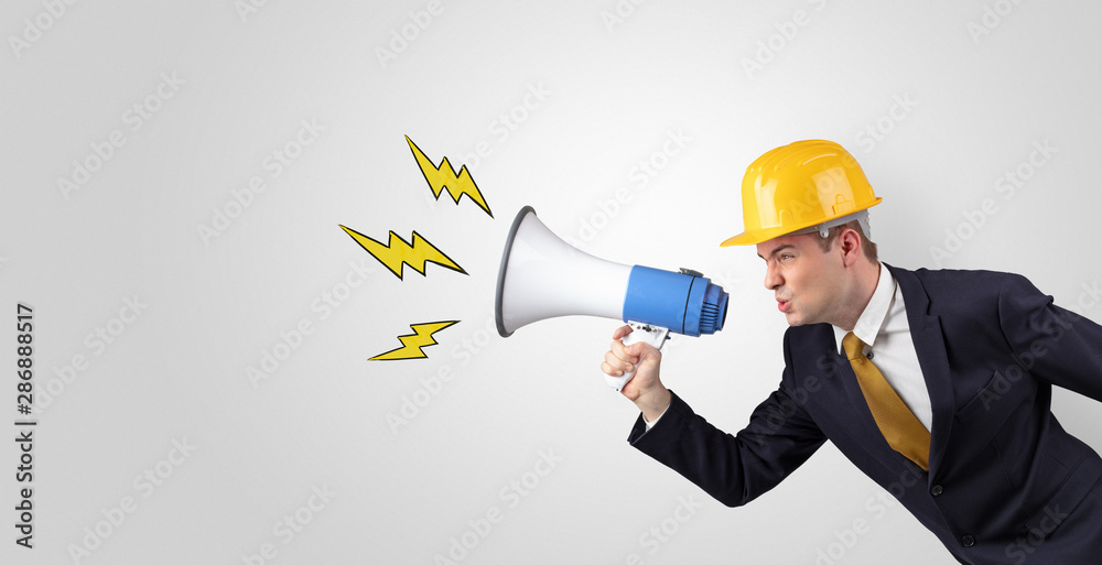 Young architect constructor yelling with megaphone and copyspace Young architect constructor yelling with megaphone and copyspace