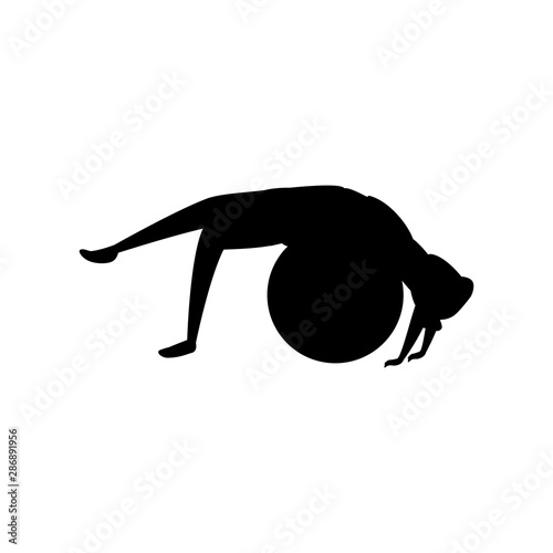 silhouette of woman practicing pilates with balloon