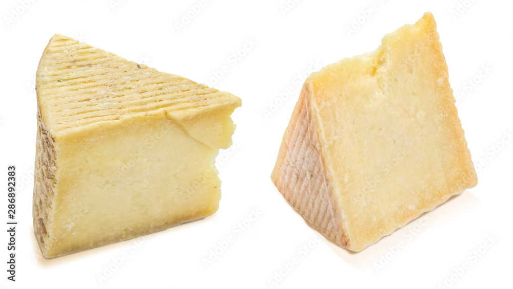 Cured sheep cheese (manchego type). Two wedges and portions. Isolated on white background.