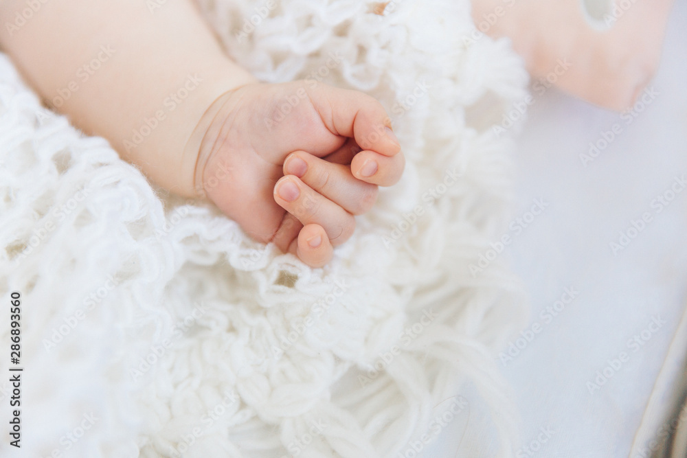 newborn baby hand in white blanket newborn baby hand in white blanket