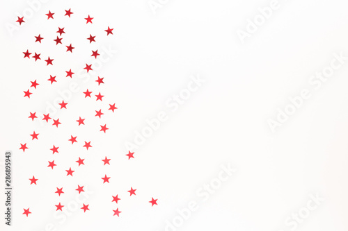 Christmas composition. Red stars on white background top view background with copy space for your text. Flat lay.