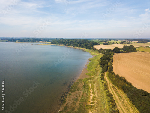 Aerial view of the River Deben and the surrounding countryside fields. A stereotypical view of the suffolk countryside © Collins Photography