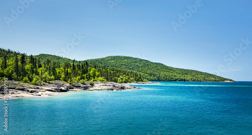 Scenic view of the forest across the beautiful Blue water of Lake Superior at Neys Provincial Park, Ontario, Canada photo
