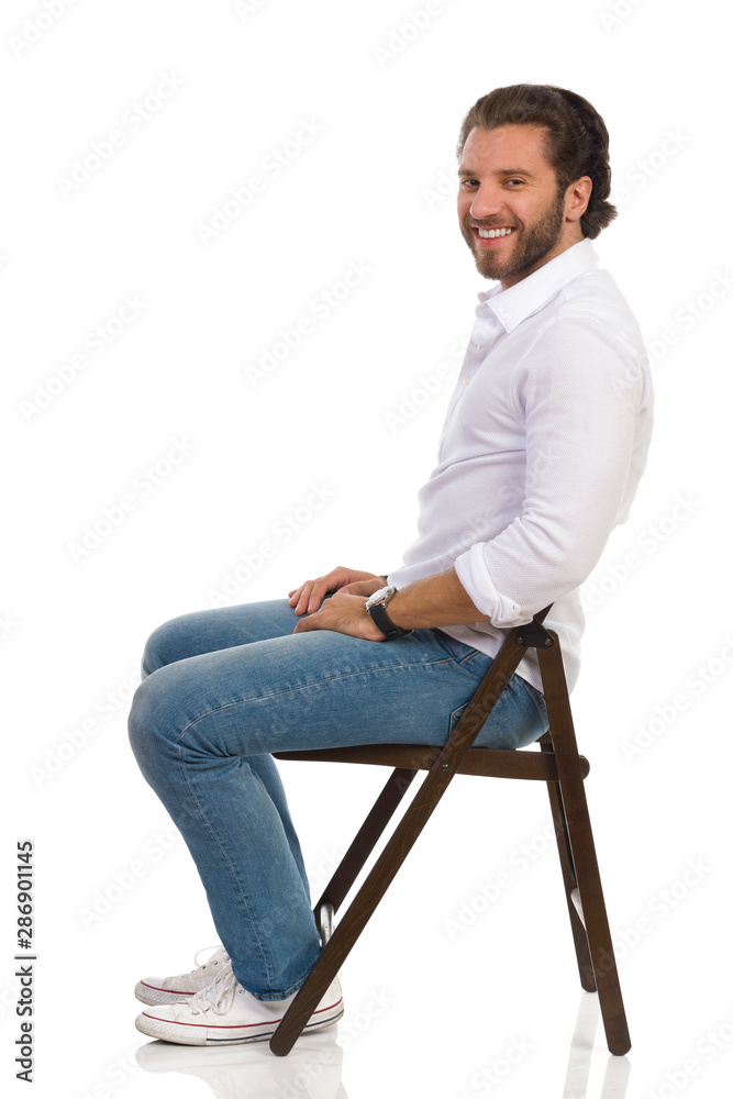 young man sitting on a chair young man sitting on a chair