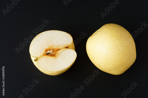 Sand pear full and half fruit isolated on black background photo