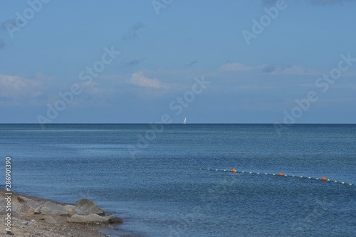 Bewegte blaue See mit weißem Segelschiff am Horizont © Brigitte Angelika  