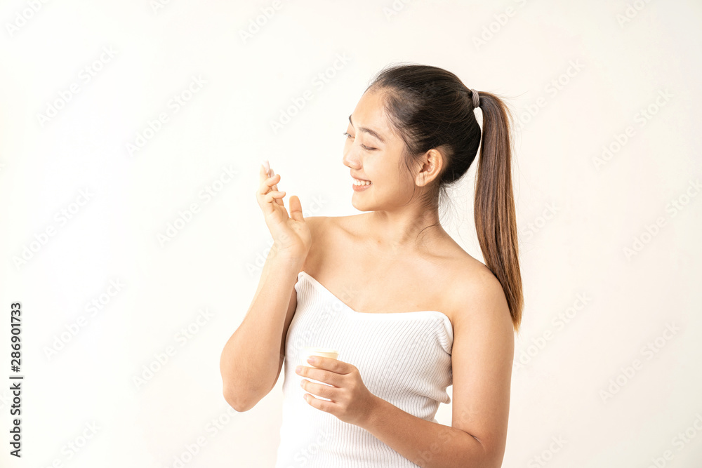 Young women experimenting with skin care creams. Two young woman applyng moisturizing cream. Beauty female with make up concept on the white background. Young women experimenting with skin care creams. Two young woman applyng moisturizing cream. Beauty female with make up concept on the white background.