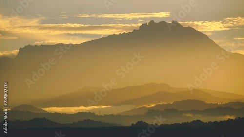 Mount Kinabalu during sunrise over Sulaman River Bridge photo