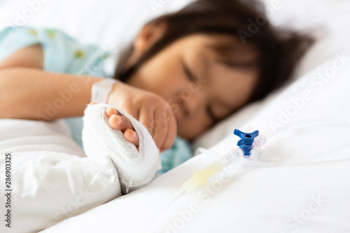 A 3-year-old Asian girl is sick in a bed 
