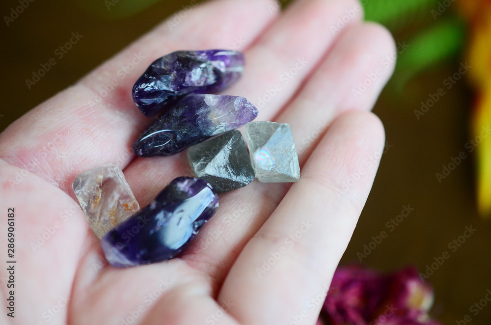 Tumbled Amethyst & Mini Fluorite Octahedron - Miniature Healing Crystal bundle, great witchy gift, magick crystals. Crystals on wood desk, healing stone mock up with copy space and low exposure. 