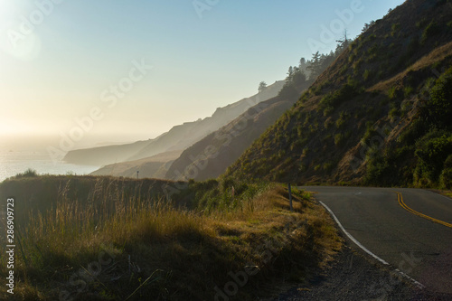 the pacific coast highway fading into the misty cliffs