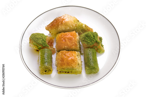 assorted baklava and turkish dessert on plate on white background