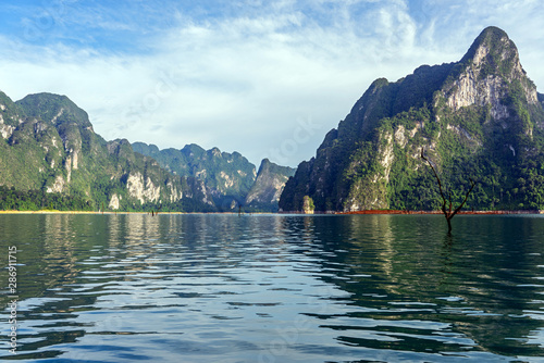 Foto Limestone mountain range and lake in afternoon light